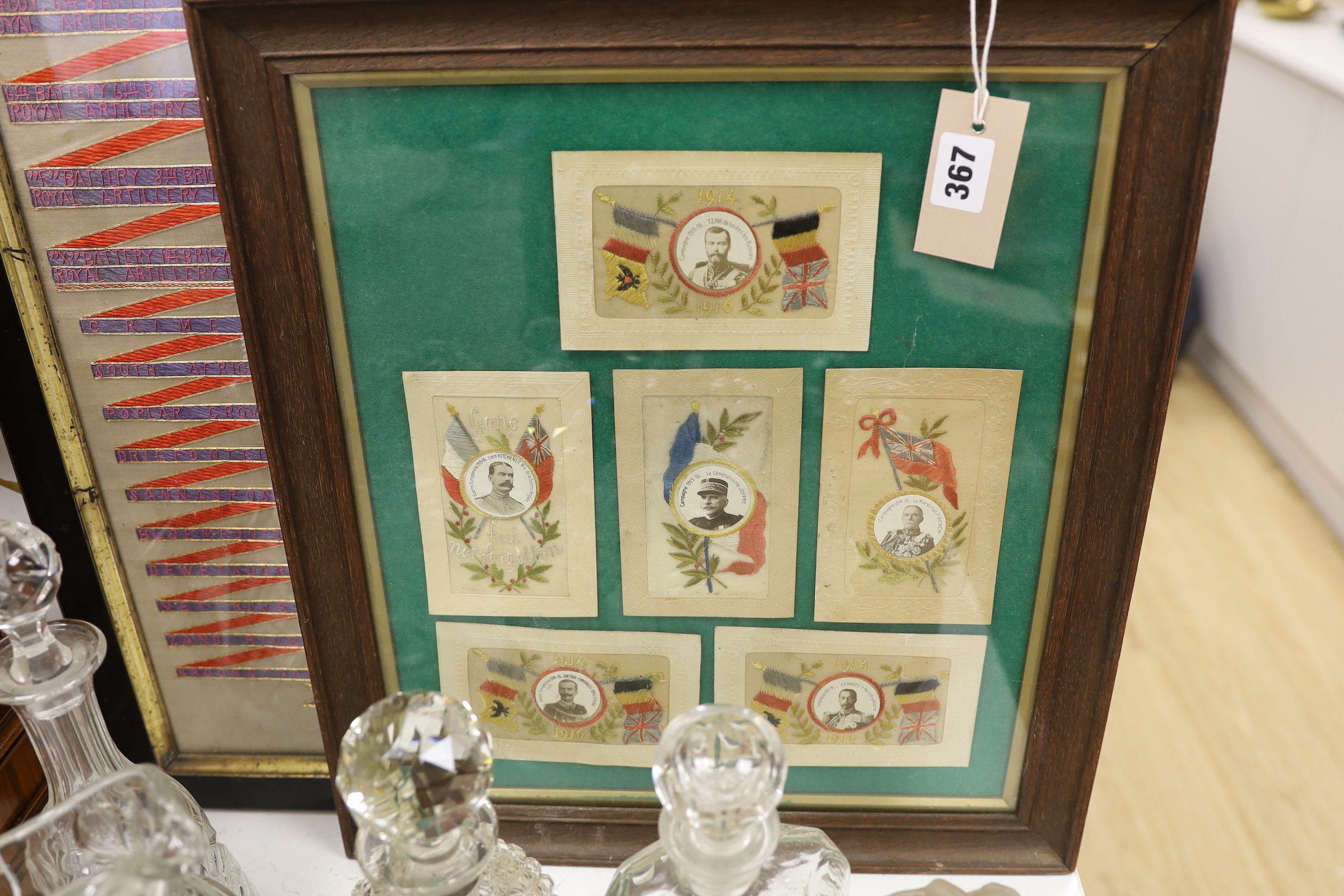 A framed Royal Field Artillery crest and six WWI postcards, framed